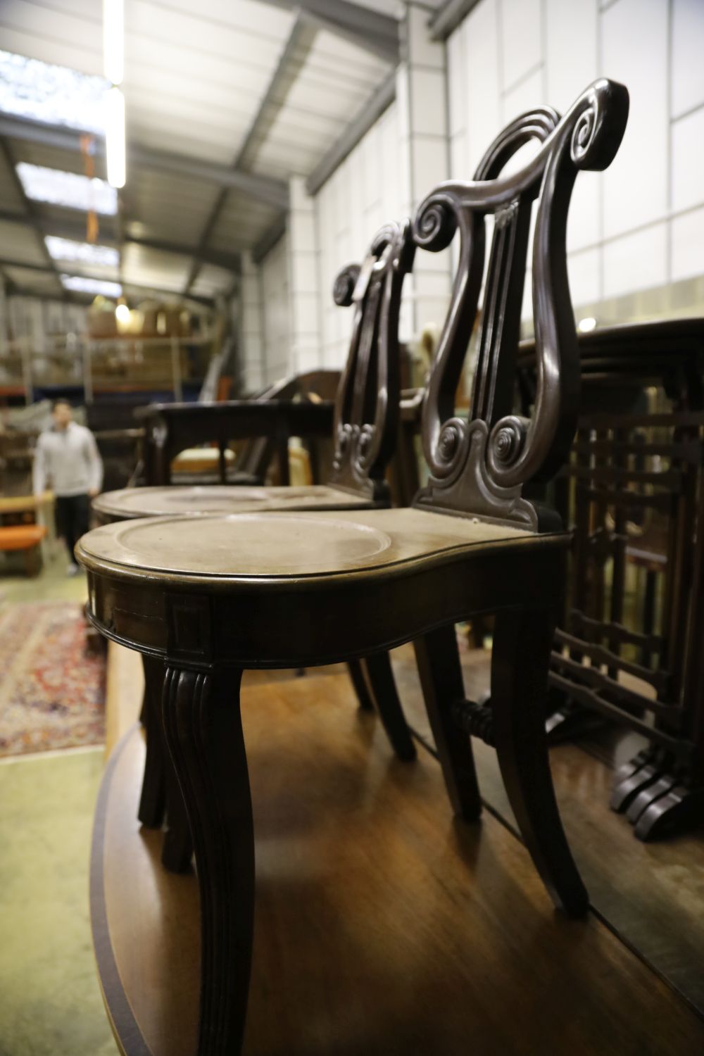 A pair of George IV style mahogany hall chairs